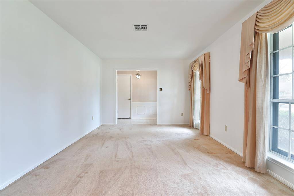 This expansive living room could become part of the den/family room with removal of the one wall.