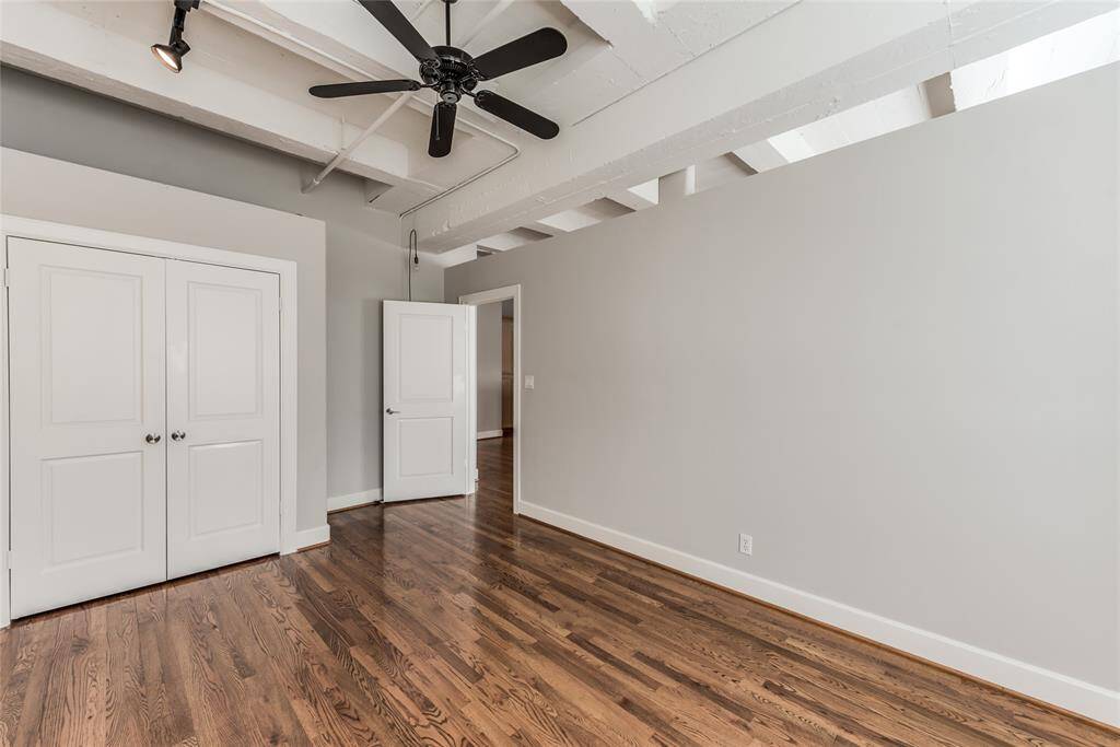 From this perspective in the second bedroom, you can see the closet space to the left, offering convenient storage. The door on the right leads into the open living room, creating a smooth transition between the rooms.