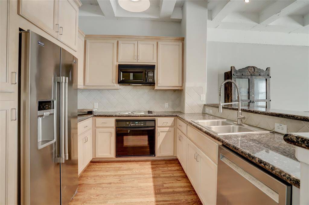 The kitchen is equipped with an electric cooktop, sleek granite countertops, and a convenient breakfast bar. It also features a pantry and plenty of cabinets, providing ample storage space for all your kitchen essentials.