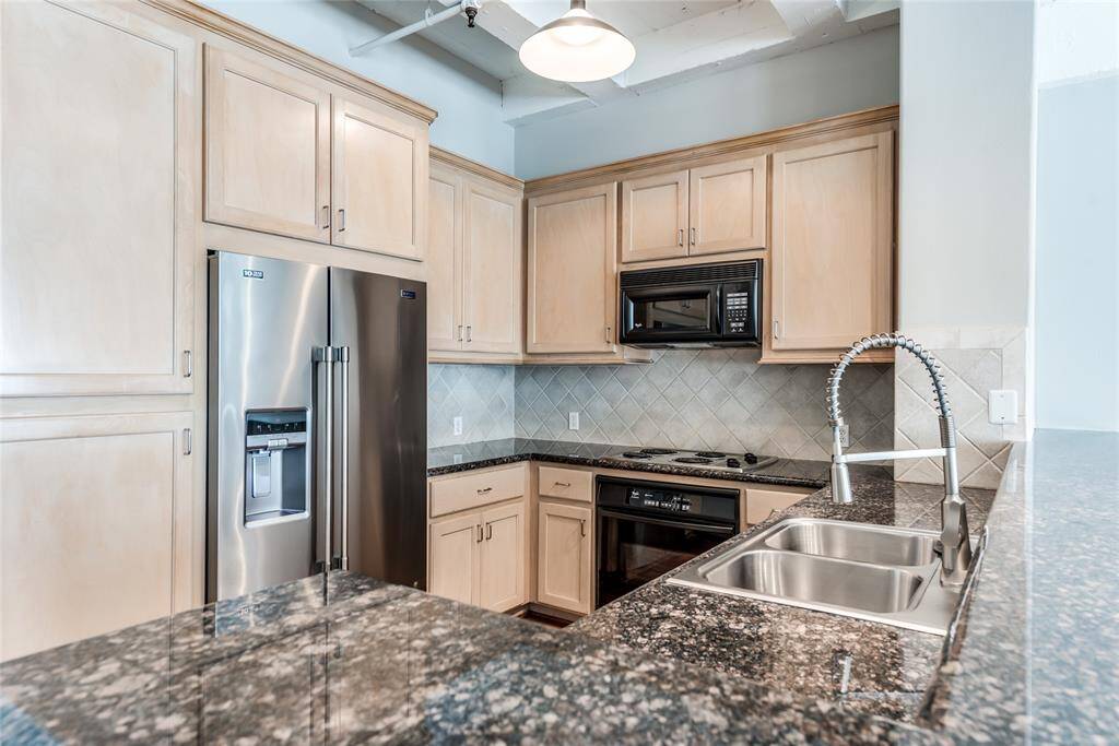 A closer look at the kitchen reveals an abundant amount of storage, with plenty of cabinets to keep everything organized. The stainless steel refrigerator is also included and will convey with the sale.