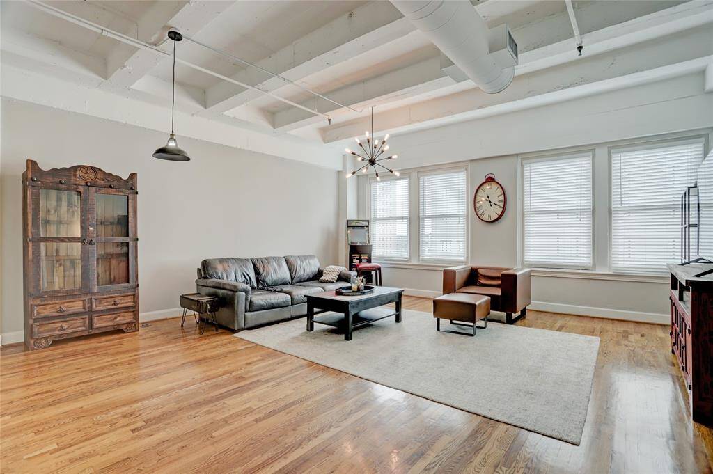 The spacious living area is perfect for entertaining, offering plenty of room to gather and relax. Four large windows flood the space with natural light, creating a bright and inviting atmosphere.