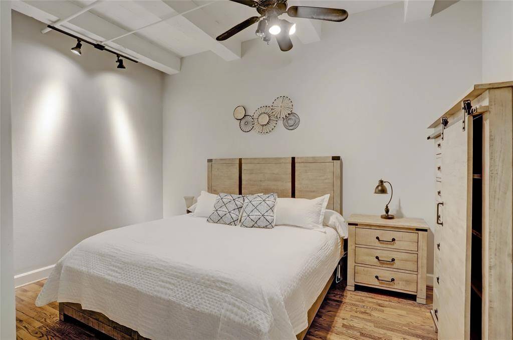 The hardwood floors extend into the primary bedroom, adding warmth and character to the space. Generously sized, it comfortably fits a king-size bed along with additional furniture to suit your needs. To the right, you'll find a spacious walk-in closet, providing ample storage.