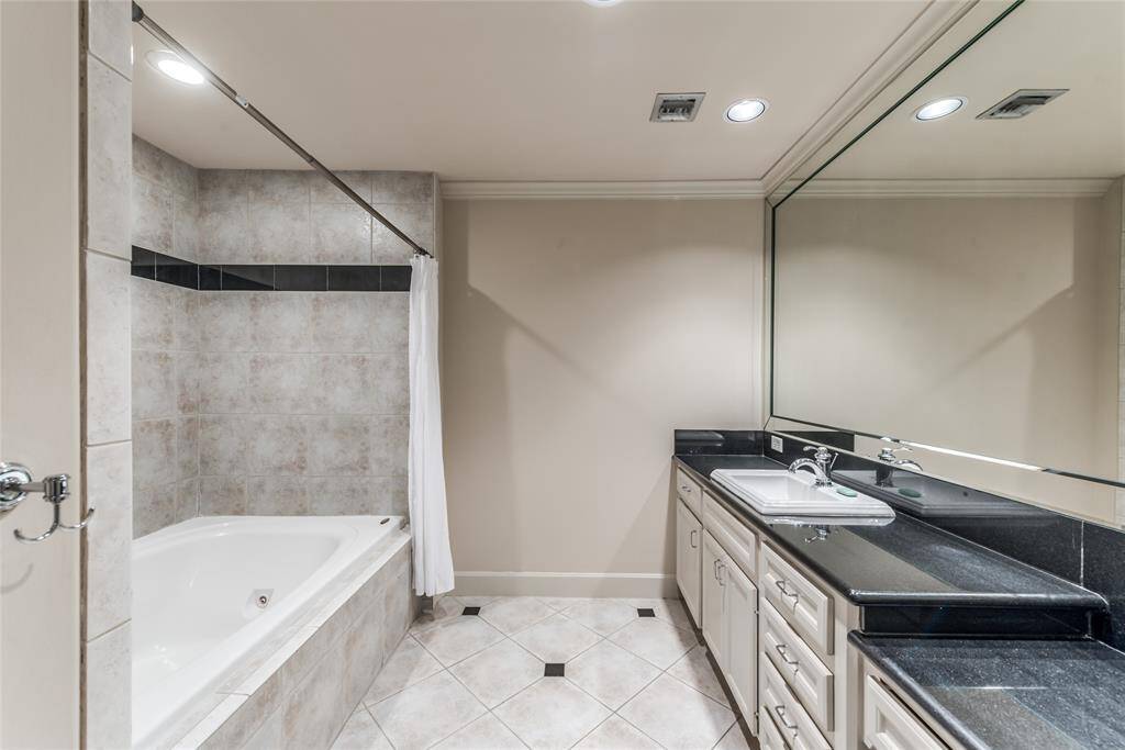 The bathroom is equally spacious, featuring a separate water closet for added privacy, a dedicated vanity area, and ample storage to keep your essentials neatly organized.