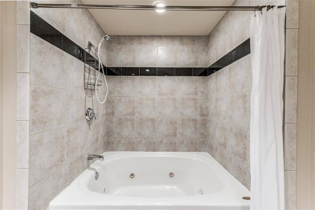 A closer look reveals the dual shower and jetted tub, offering both convenience and relaxation for your daily routine.