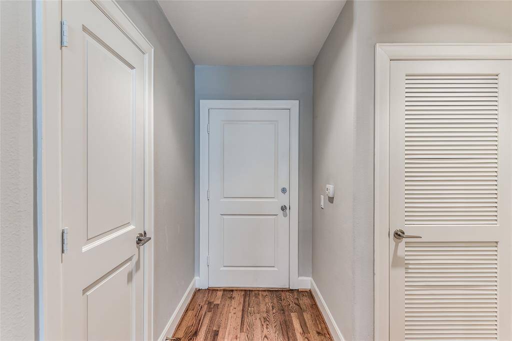 From the opposite view of the main entrance, the door on the left reveals a convenient coat closet, while the door on the right provides access to the HVAC system.