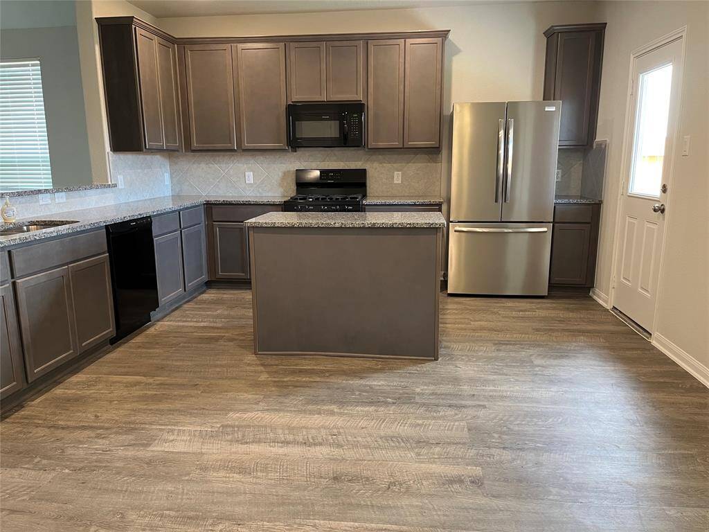 kitchen area with new fridge