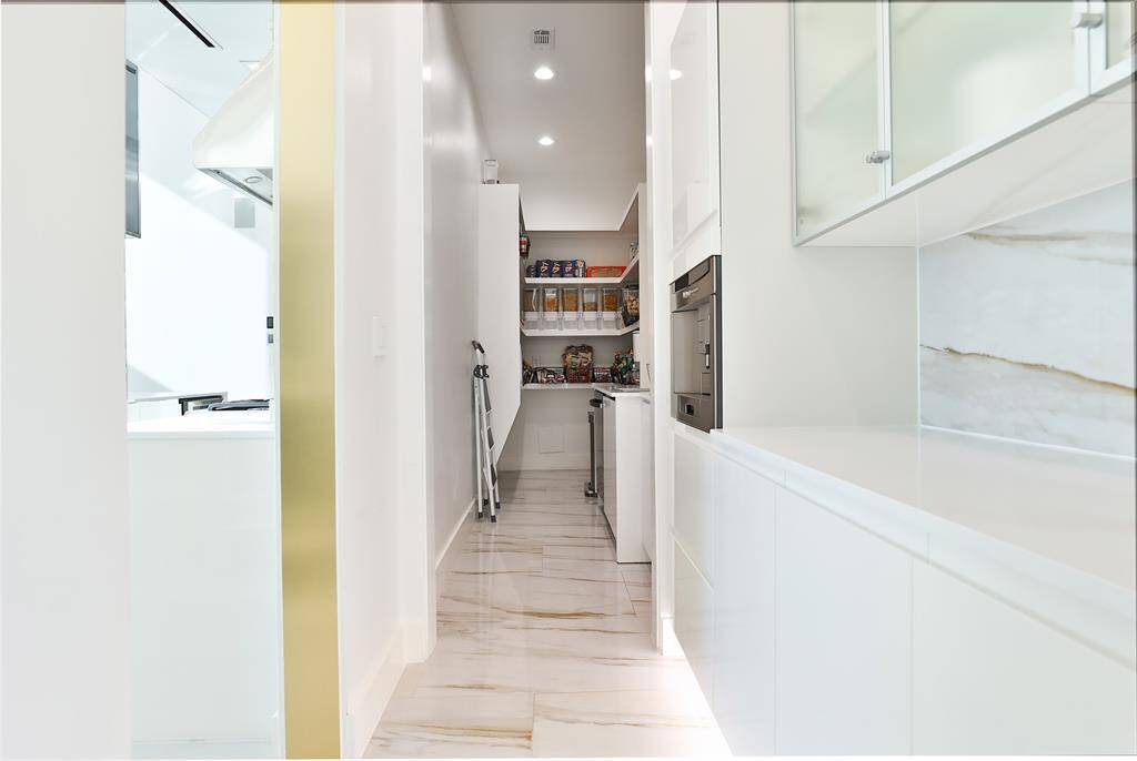 Your coffee bar awaits mornings on the go with the built-in Thermador coffee station and pantry amongst the custom cabinets. An additional stainless undermount sink for kitchen prep and second dishwasher keep clutter at bay for party planning.