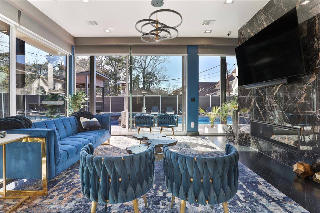 Every individual hand crafted detail in this room screams palatial from the corner windowed wall with custom window treatments to the midnight wood floors and opulent fireplace.