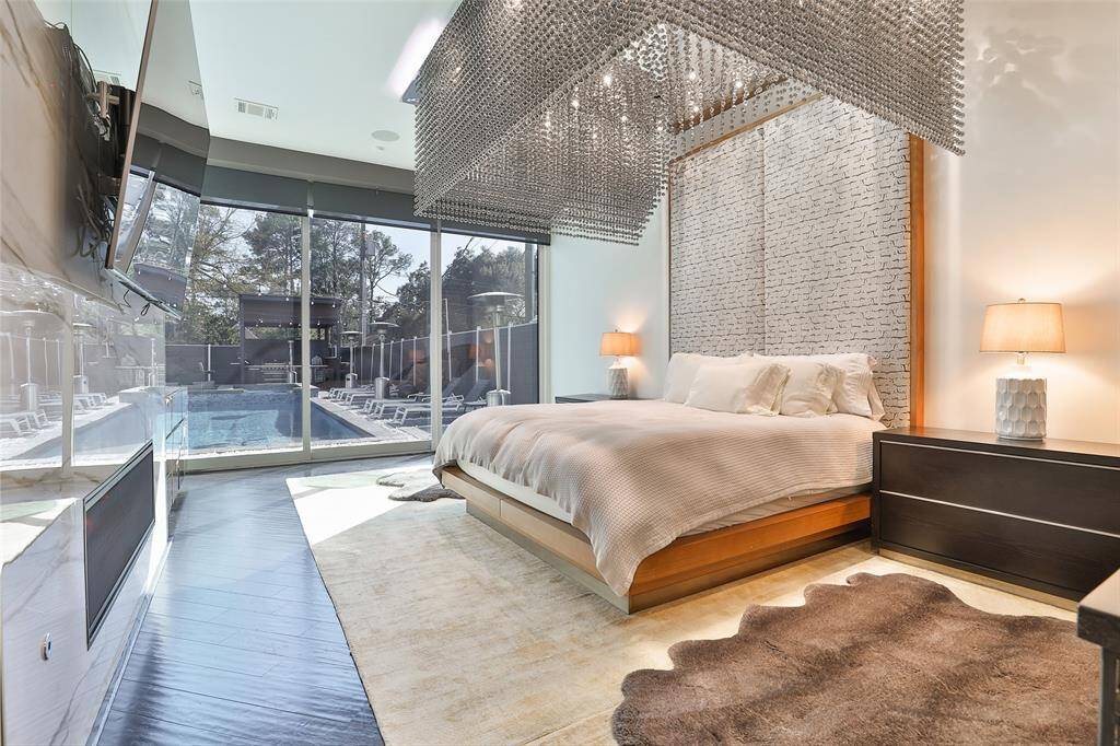 The masculine wood floors warm the space and the beaded chandelier and floor to ceiling crisp white fireplace wall give feminine energy for the perfect pairing.