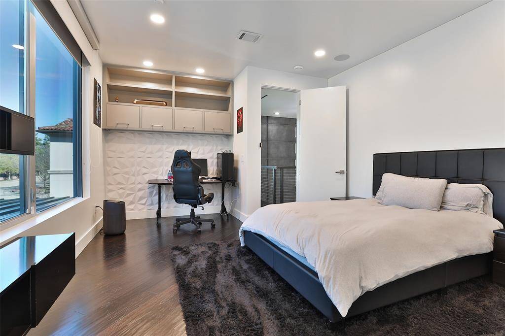 The front guest bedroom overlooks the statley front yard. An energy efficient wall of windows are TRIPLE pane and noise canceling for an amazing nights rest!