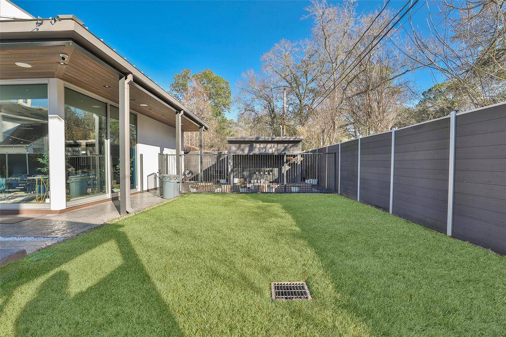 View of the fully fenced in "Farmers Market" and green space for pets and kiddos to roam and frolic. Note the surround speakers speakers surrounding the pool.