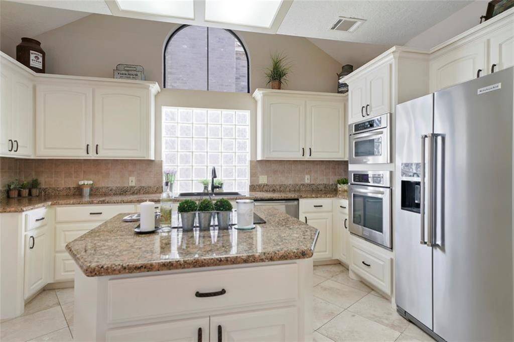 Bright and spacious kitchen featuring granite countertops, stainless steel appliances, and ample storage. Perfect for culinary enthusiasts!