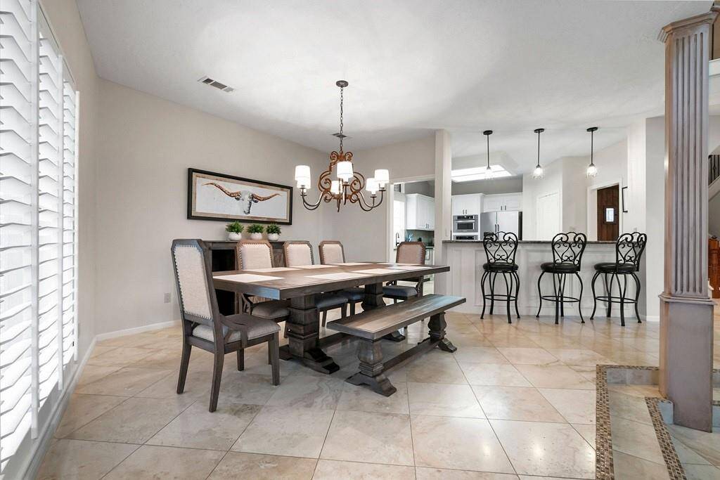 Elegant dining area with ample natural light and a seamless flow to the kitchen, perfect for entertaining.