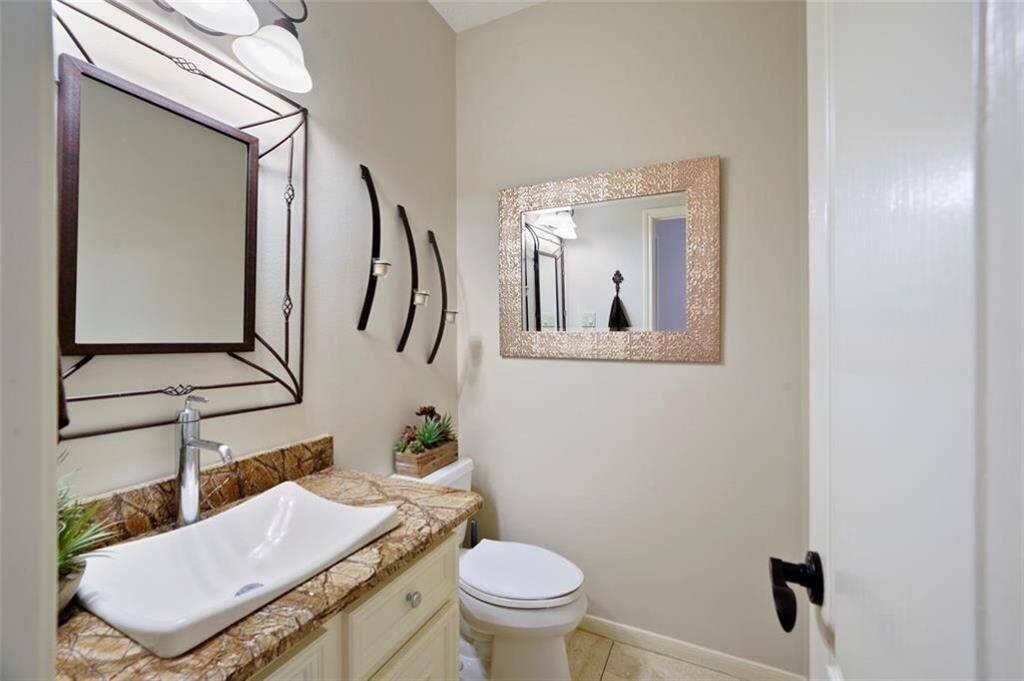 Stylish half bath featuring a modern vessel sink and elegant decor, perfect for guests.