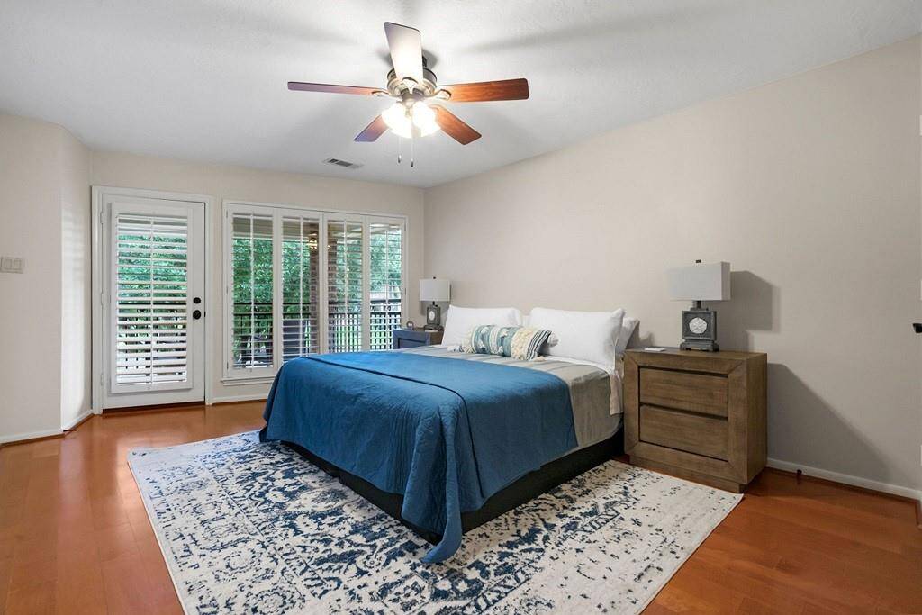 Spacious upstairs bedroom with abundant natural light and serene views.
