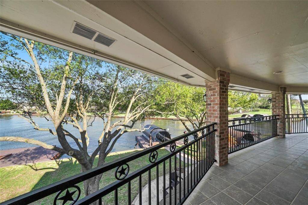 Expansive upstairs balcony with serene waterfront views.