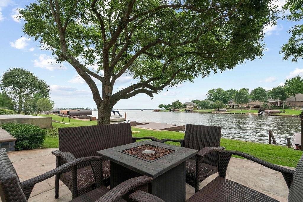 This inviting patio offers a serene lakeside view, perfect for relaxation and entertaining.