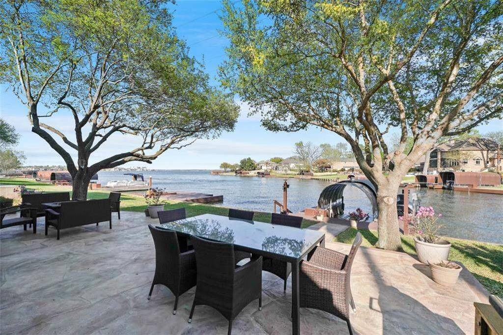 This stunning patio offers serene waterfront views, surrounded by lush greenery—perfect for relaxing or entertaining.