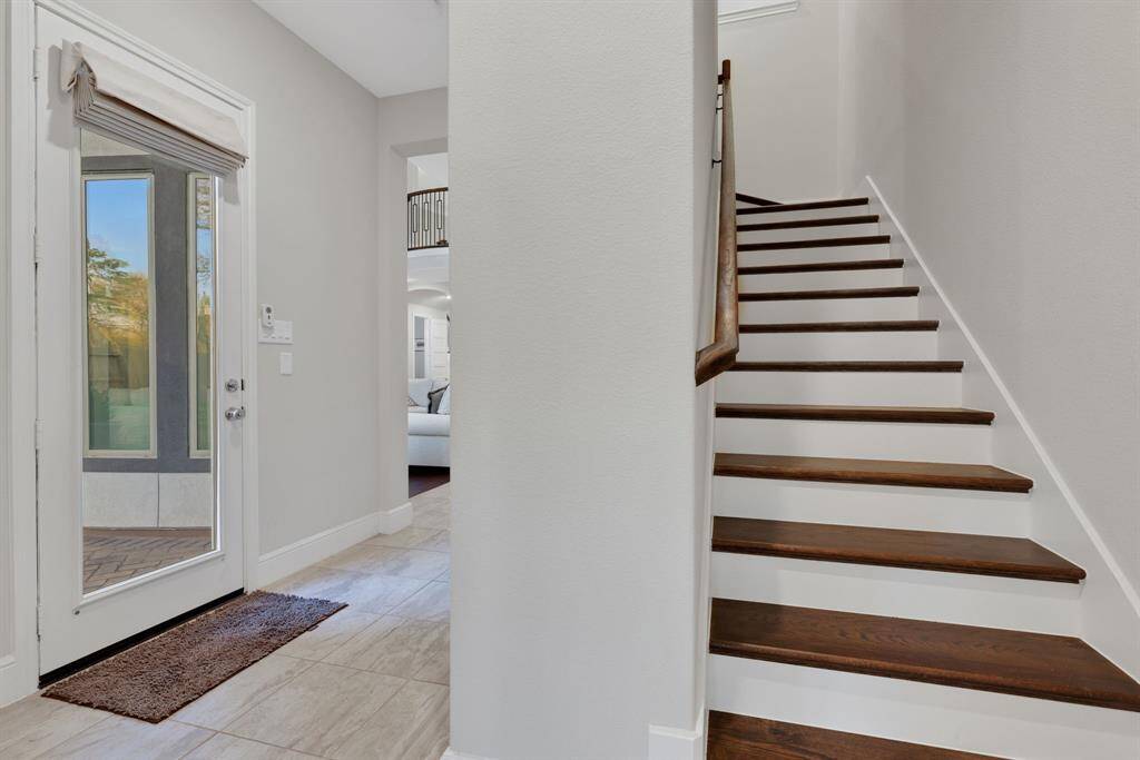 Back staircase to allow easy access to the second story. Located just inside from the three-car tandem garage.