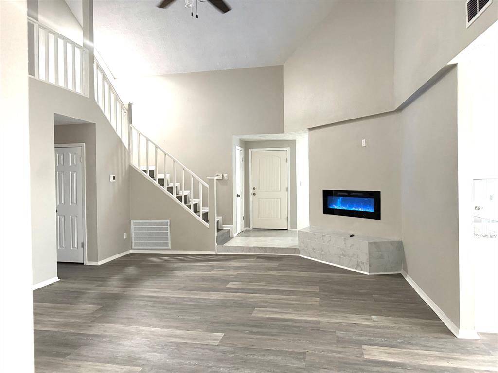 living room facing the front door. Formal dining room is just behind the fireplace