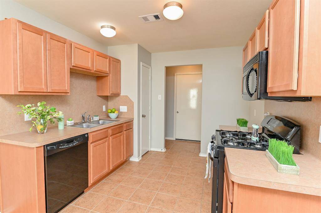 Modern kitchen with convenient access to the backyard through the backdoor.