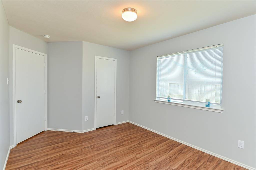 Inviting guest bedroom with abundant natural light and pristine finishes.