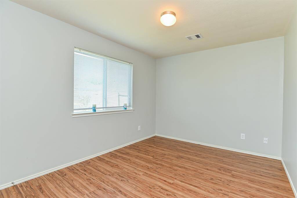Guest Bedroom 2: Spacious with high ceilings and recent laminate floors.