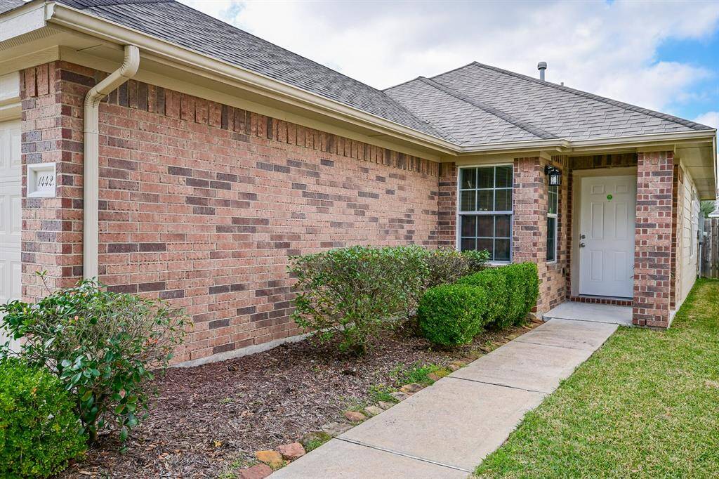 Charming brick entry with a welcoming covered patio.