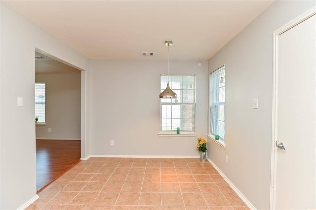 Bright breakfast area with views of the charming wood garage door.