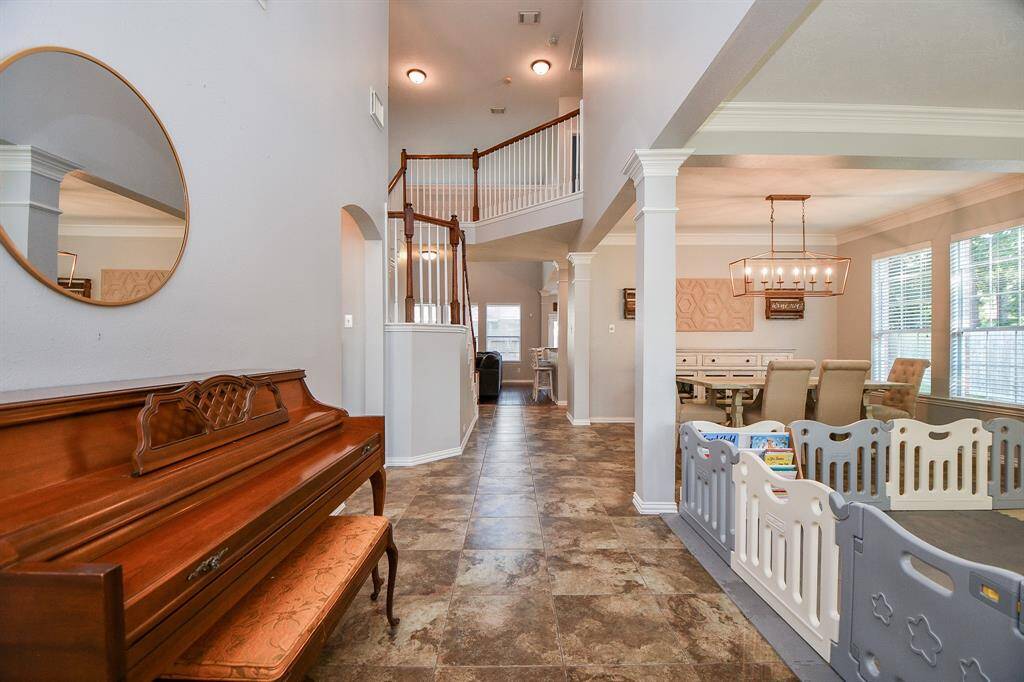 Bright entryway with soaring ceilings, offering an inviting and spacious feel.