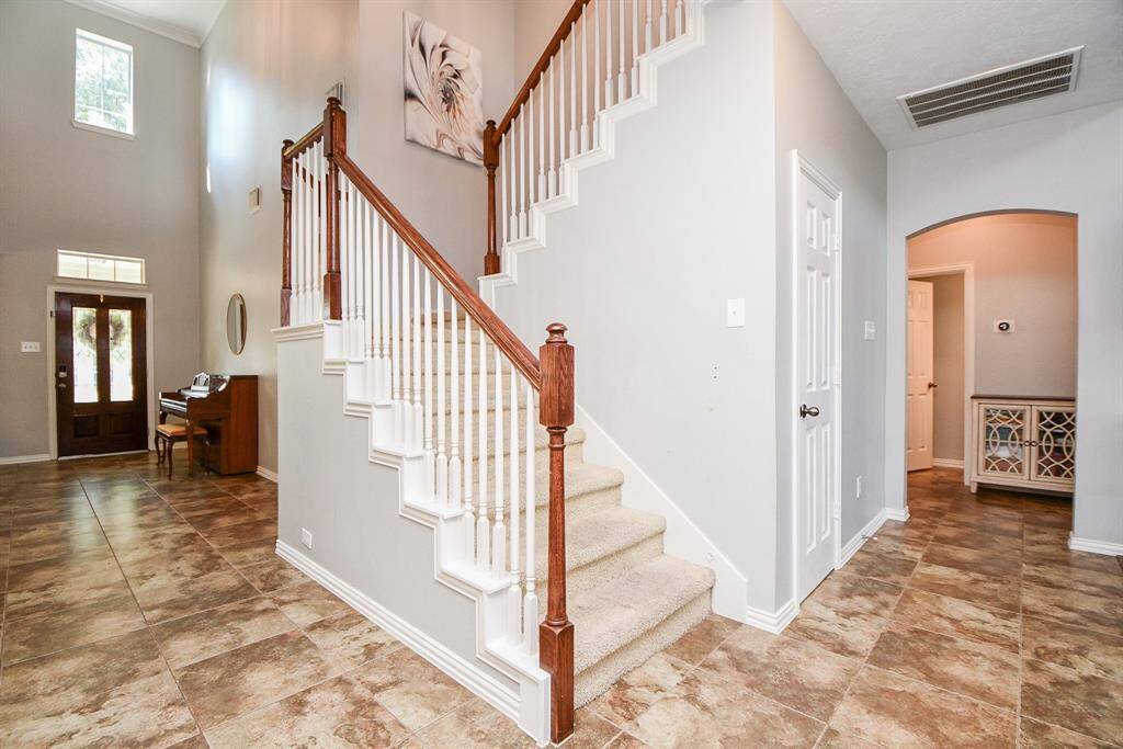 Elegant staircase with spacious storage closet.