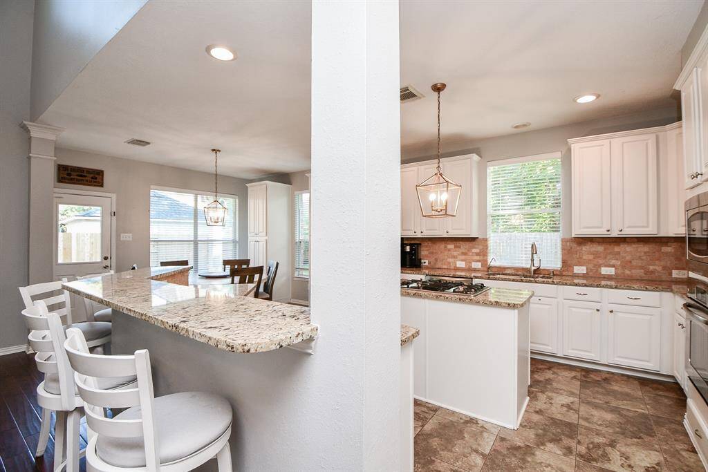 Spacious kitchen with ample seating, perfect for entertaining.