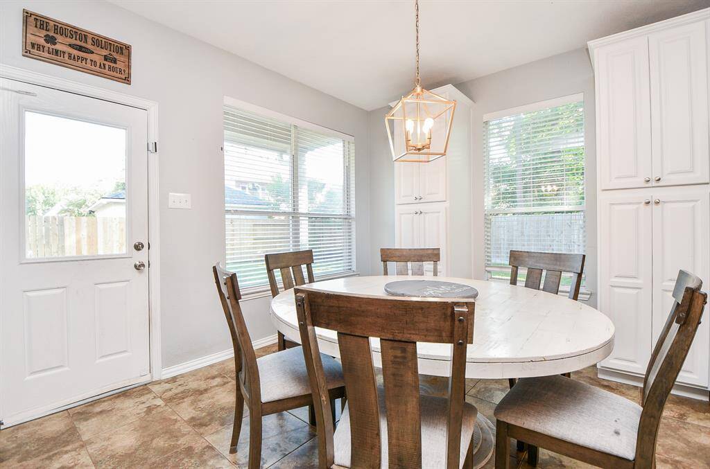 Cozy breakfast nook with abundant natural light and charming backyard views.