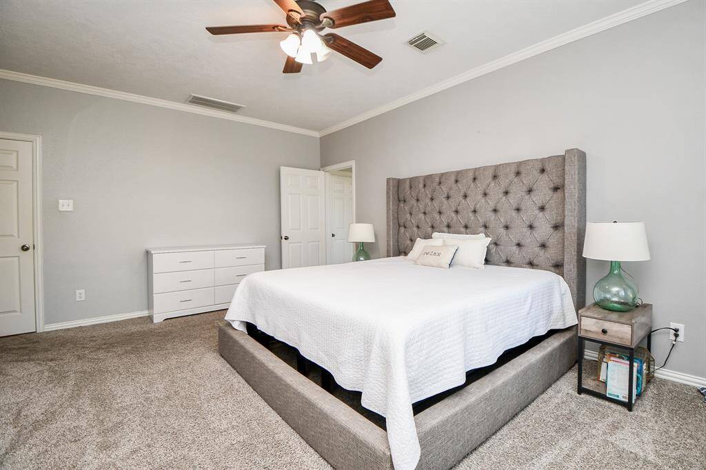 Spacious master bedroom with elegant design and ample natural light.