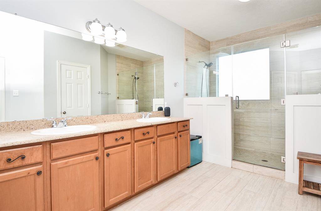 Experience luxury in the master bathroom, featuring a spacious dual shower and elegant double vanities.