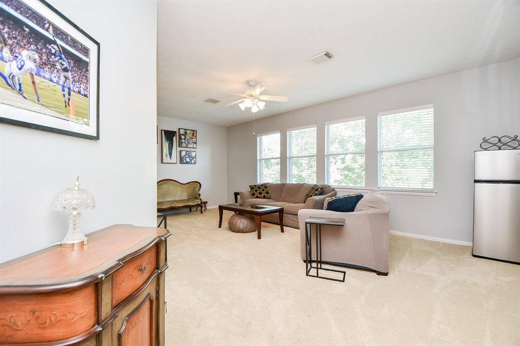 Spacious second-floor living room bathed in natural light.