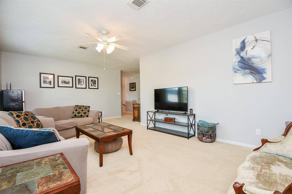 Bright and spacious upstairs living room, perfect for relaxation and entertainment.