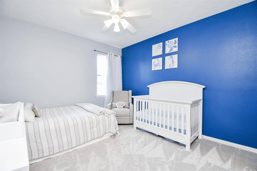 Upstairs fourth bedroom offers versatile space and bright natural light.