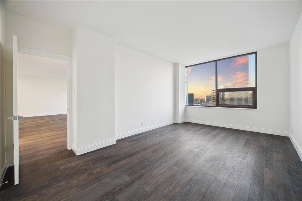A bright, spacious Primary bedroom with large windows (one can open).