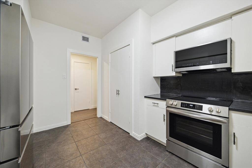 New appliances and the double doors open to reveal the clothes washer and dryer.