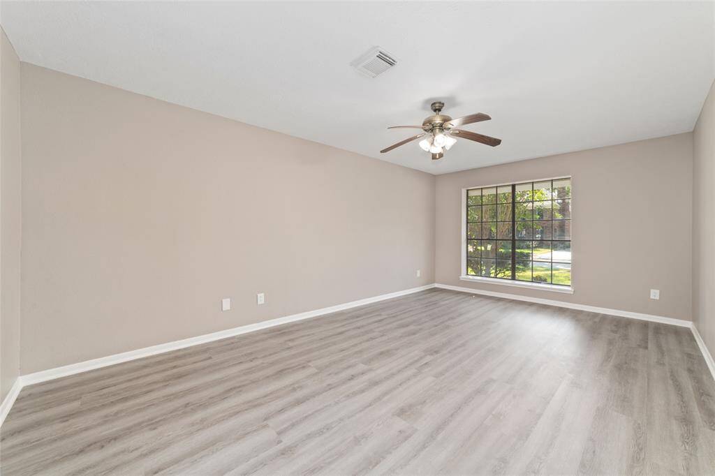 The downstairs primary bedroom can easily fit a king-sized bedroom suite of furniture and still have room to spare.