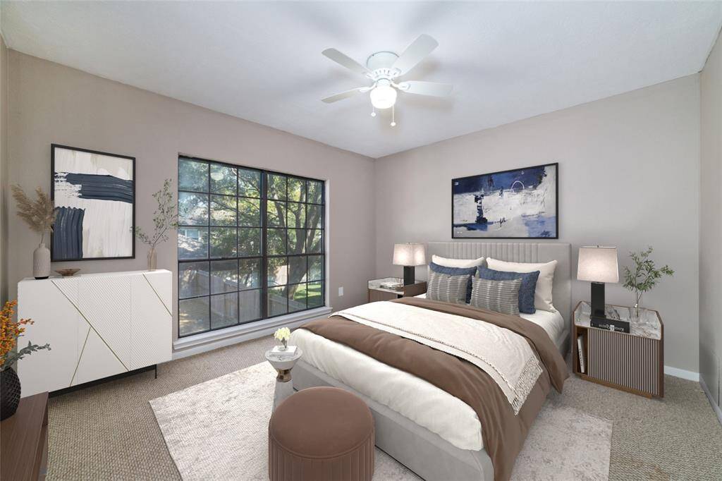 Comfort awaits in the secondary bedrooms with natural light streaming in through large windows, views overlooking the yard, soothing decor tones, generous closet space, and energy efficient ceiling fans. All secondary bedrooms are approximately the same size. Virtually staged.