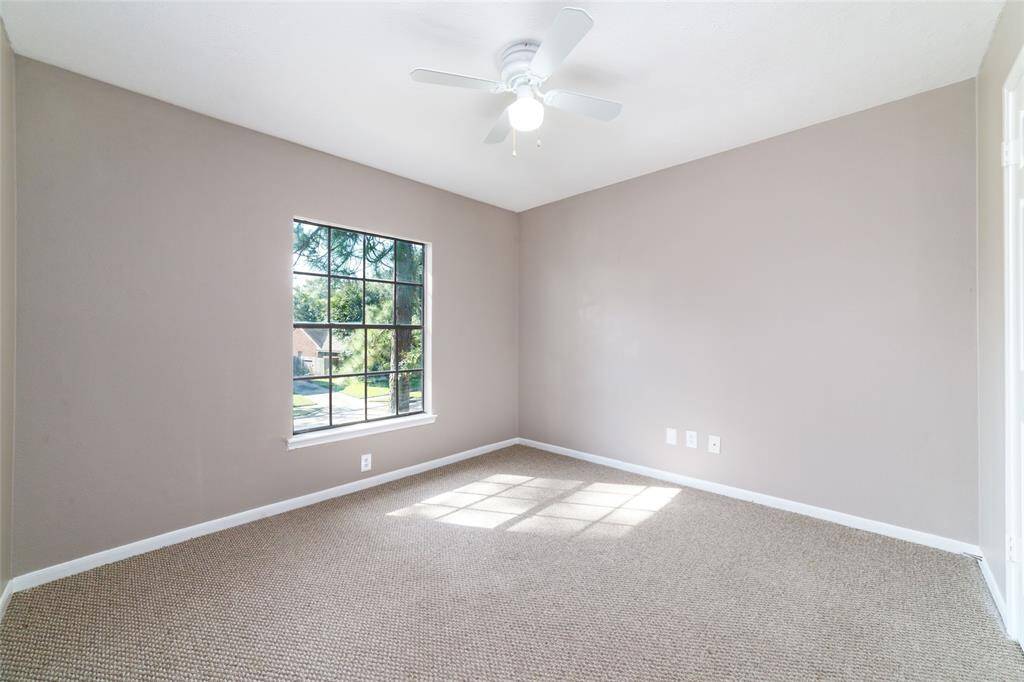 Inviting secondary bedroom with soothing neutral palette and ample natural light.