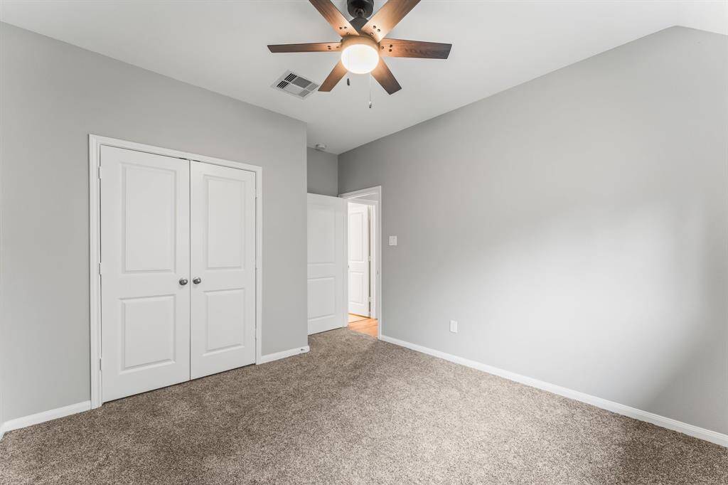 The third bedroom, also with newly updated carpet, is located to the right of the front and secondary bedrooms.