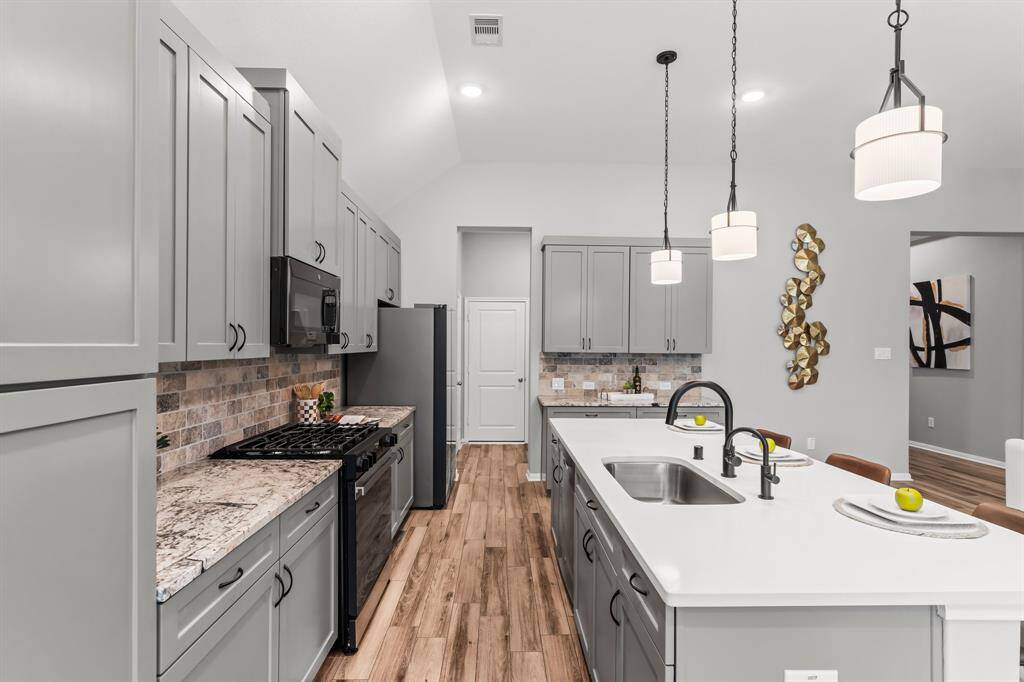 Kitchen has ample storage and generous space for entertaining, it’s the perfect blend of function and style.