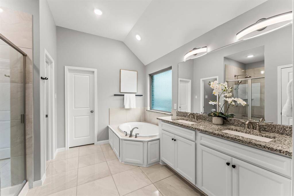 Looking from the primary bedroom toward its expansive ensuite bathroom.