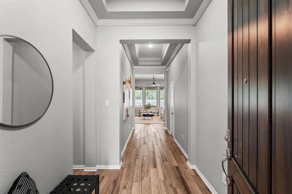 A welcoming front entrance with a brick exterior, featuring a covered porch area and a glass-paneled door, giving it a classic and inviting look.
