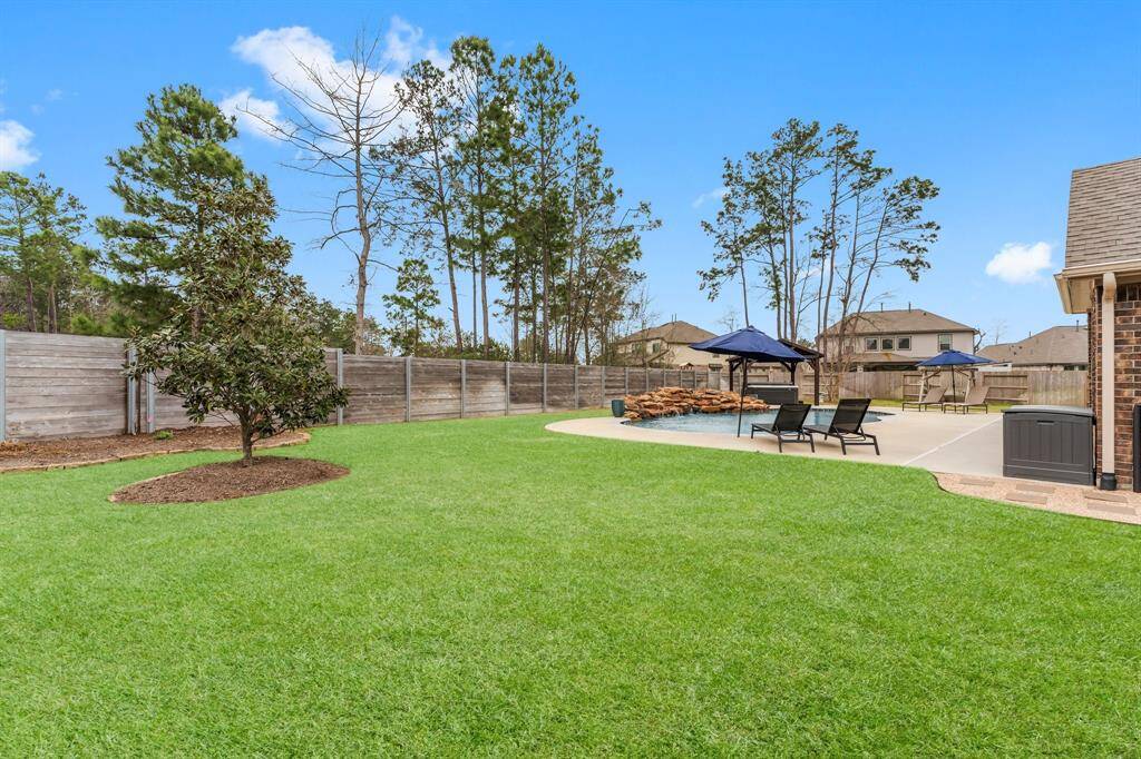Relax in your hot tub under a charming pergola, glowing with string lights for year-round ambiance.  The attached cover keeps it sparkling clean, ready for quiet evenings or lively gatherings.  From summer fun to winter warmth, this inviting space welcomes you in every season.
