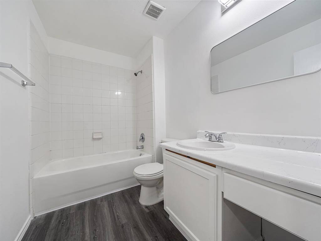 Secondary bathroom next to the game room has new water-proof laminate flooring, new mirror and vanity with sitting area!
