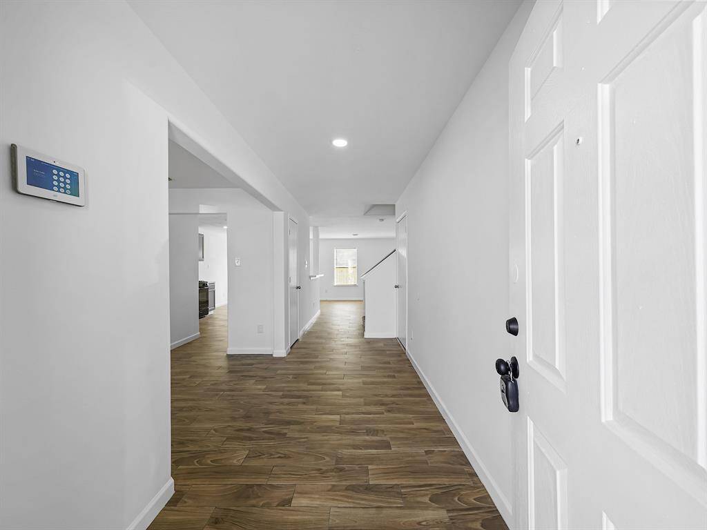 As you step through the front door, you'll be greeted by soothing neutral tones that create a calming atmosphere throughout the entire living space. The luxurious wood-look vinyl flooring that flows seamlessly across the first floor not only enhances the aesthetic appeal but also provides durability and ease of maintenance for everyday living.